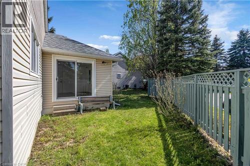 Private side yard featuring a sliding glass door entry and light-toned horizontal siding - 375 Silverbirch Boulevard, Hamilton, ON - Outdoor