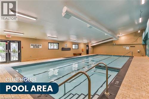 Indoor swimming pool featuring an integrated shallow end, tiled surround, and multiple entry points with metal handrails - 375 Silverbirch Boulevard, Hamilton, ON - Indoor Photo Showing Other Room With In Ground Pool