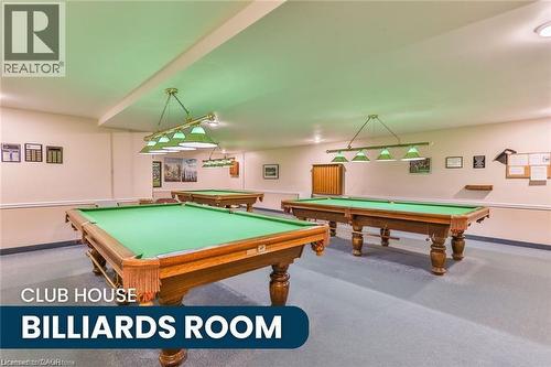 Dedicated billiards room featuring multiple billiard tables, overhead task lighting, wall-mounted display boards, and carpet flooring - 375 Silverbirch Boulevard, Hamilton, ON - Indoor Photo Showing Other Room