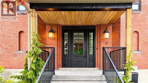Brick facade featuring a covered front entry with natural wood ceiling - 41 Talbot Road, Delhi, ON - Outdoor With Exterior