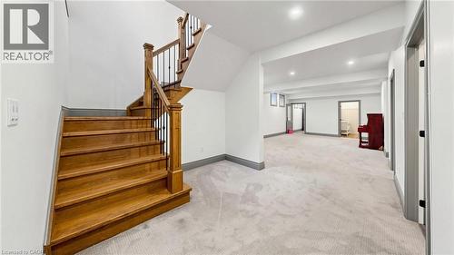 Staircase featuring wood treads, wood newel post, and black iron balusters - 41 Talbot Road, Delhi, ON - Indoor Photo Showing Other Room