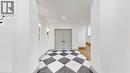 Entryway featuring a black and white checkered floor, two wall sconces, a pair of paneled doors, and a recessed ceiling light - 41 Talbot Road, Delhi, ON  - Indoor 