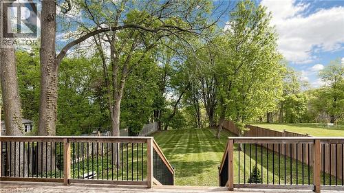 Spacious outdoor deck with natural wood railing and black metal balusters - 41 Talbot Road, Delhi, ON - Outdoor