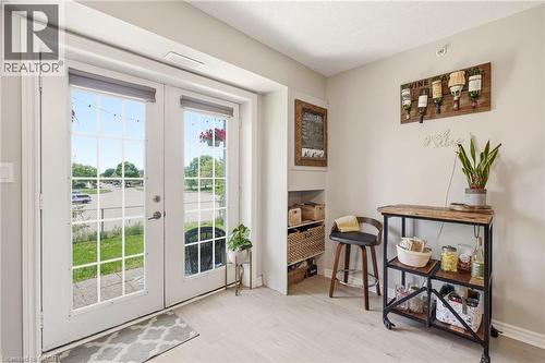 Double French doors with divided lites and roller shades - 1411 Walker'S Line Unit# 105, Burlington, ON - Indoor Photo Showing Other Room