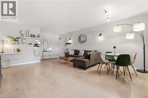 Open-concept living space with light-toned wood-finish flooring - 1411 Walker'S Line Unit# 105, Burlington, ON - Indoor
