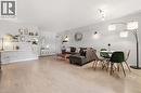 Open-concept living space with light-toned wood-finish flooring - 1411 Walker'S Line Unit# 105, Burlington, ON  - Indoor 