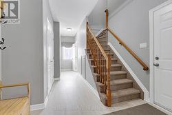 Stairs to upper level, hall to powder rm & garage - 