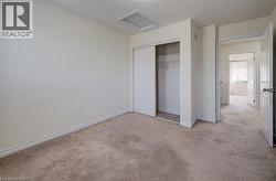 Neutral-toned wall-to-wall carpeting and off-white walls - 