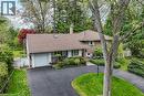 Brick and siding exterior featuring a detached single-car garage, asphalt driveway, and mature landscaping - 2 Summit Circle, Simcoe, ON  - Outdoor 