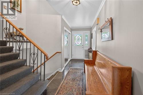 Entryway featuring a white front door with decorative glass, sidelights, and transom window - 2 Summit Circle, Simcoe, ON - Indoor Photo Showing Other Room