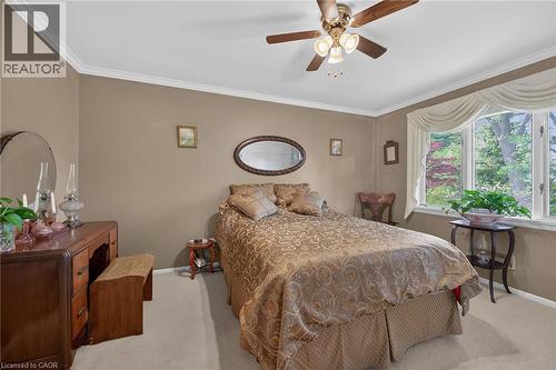 Neutral-toned walls with white crown molding and carpeted flooring - 2 Summit Circle, Simcoe, ON - Indoor Photo Showing Bedroom
