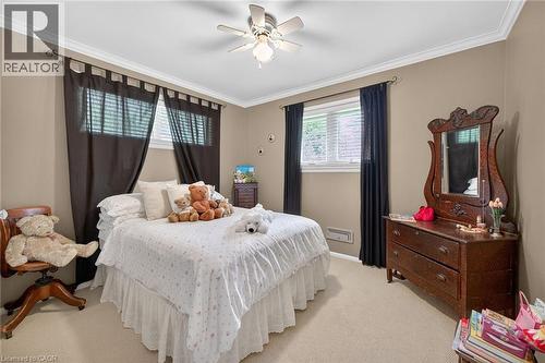Carpeted bedroom featuring neutral-toned walls and white crown molding - 2 Summit Circle, Simcoe, ON - Indoor Photo Showing Bedroom
