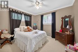 Carpeted bedroom featuring neutral-toned walls and white crown molding - 