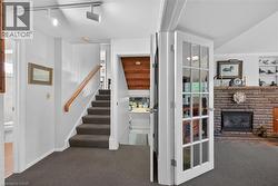 Interior entryway featuring carpeted flooring and white trim - 
