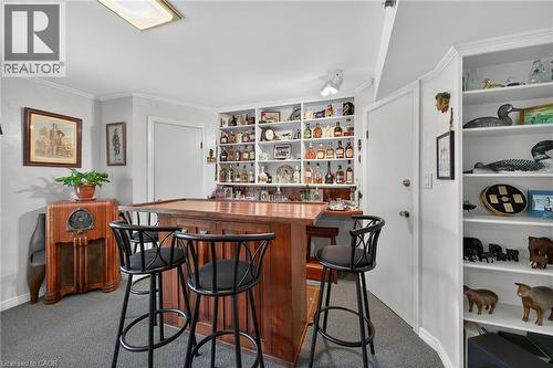 A cozy room with integrated shelving, and built-in display shelves - 2 Summit Circle, Simcoe, ON - Indoor