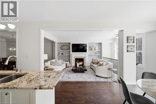 Kitchen countertop with granite-style finish and stainless steel sink - 2466 Village Common, Oakville, ON - Indoor With Fireplace