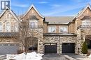 Stone and brick facade featuring multiple gables and a bay window with a wrought iron balcony - 2466 Village Common, Oakville, ON  - Outdoor With Facade 