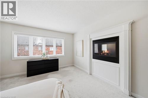 Wall-mounted fireplace with ornate white trim and mantel - 2466 Village Common, Oakville, ON - Indoor