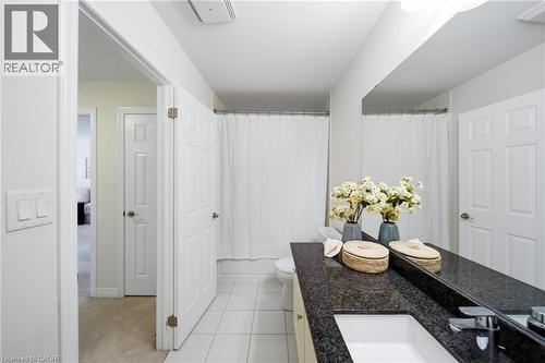 Bathroom featuring a granite countertop vanity with an undermount sink and chrome faucet - 2466 Village Common, Oakville, ON - Indoor