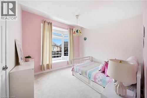Bright room featuring a bay window, plush carpet flooring, and a flush-mount ceiling light fixture - 2466 Village Common, Oakville, ON - Indoor Photo Showing Bedroom