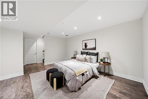 Spacious room featuring wood-finish flooring, recessed lighting, and white baseboards - 2466 Village Common, Oakville, ON - Indoor Photo Showing Bedroom