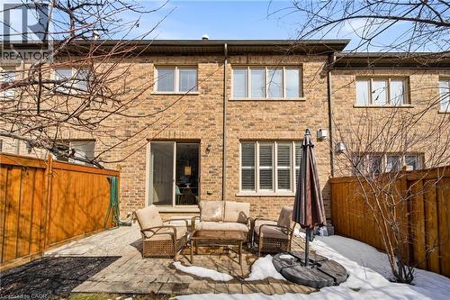 Brick exterior featuring multiple windows and a sliding glass door - 2466 Village Common, Oakville, ON - Outdoor
