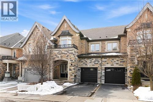Stone and brick facade with gabled roof lines - 2466 Village Common, Oakville, ON - Outdoor With Facade