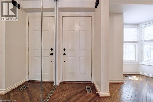 Entryway featuring warm wood-finish flooring and a full-length mirrored closet door - 463 Blathwayte Lane, Burlington, ON - Indoor Photo Showing Other Room