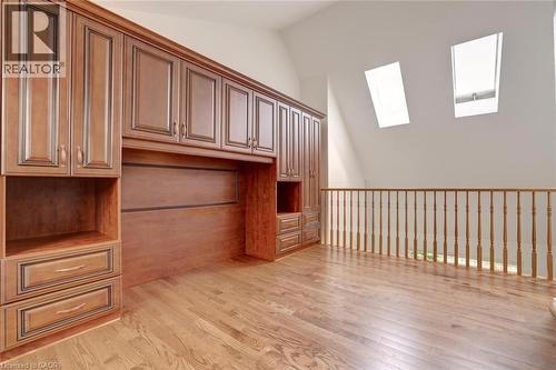Integrated wood-finish cabinetry system with a built-in desk area - 463 Blathwayte Lane, Burlington, ON - Indoor Photo Showing Other Room