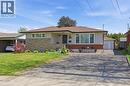 Ranch-style residence featuring a brick and stone facade, paved driveway, carport, and detached garage - 168 Nugent Drive, Hamilton, ON  - Outdoor 