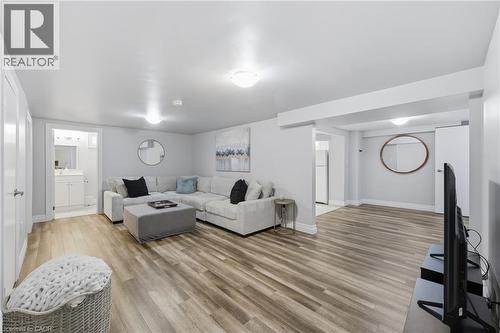 Open concept living area featuring wood-finish flooring, recessed lighting, and light gray wall tones - 168 Nugent Drive, Hamilton, ON - Indoor