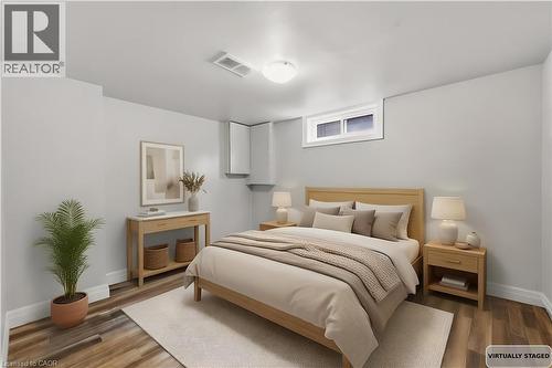 Room featuring wood-finish flooring, light gray wall paint, and a white ceiling with recessed lighting - 168 Nugent Drive, Hamilton, ON - Indoor Photo Showing Bedroom