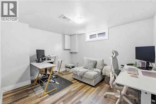 Versatile room featuring wood-finish flooring, light grey walls, and a recessed window - 168 Nugent Drive, Hamilton, ON - Indoor Photo Showing Office