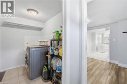 Dedicated laundry area featuring tile flooring and a neutral color palette - 