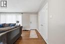 Hardwood-style flooring extends from the entryway, featuring a solid white entry door - 168 Nugent Drive, Hamilton, ON  - Indoor Photo Showing Other Room 