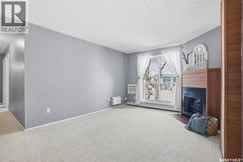 214 207C Tait Place, Saskatoon, SK - Indoor Photo Showing Other Room With Fireplace