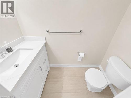 Bathroom featuring a white vanity with integrated sink, chrome faucet, and coordinating hardware - 16 Glennie Court, Cambridge, ON - Indoor Photo Showing Bathroom