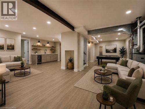 Spacious lower-level entertainment area featuring wood-finish flooring, recessed lighting, and exposed ceiling beams - 16 Glennie Court, Cambridge, ON - Indoor Photo Showing Living Room