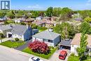Residential property featuring a light blue exterior, a dark gray shingle roof, and a paved driveway - 94 Clarendon Avenue, Hamilton, ON  - Outdoor 
