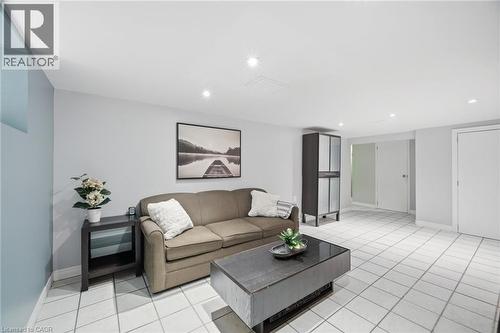 Spacious interior featuring white tiled flooring throughout - 94 Clarendon Avenue, Hamilton, ON - Indoor Photo Showing Living Room
