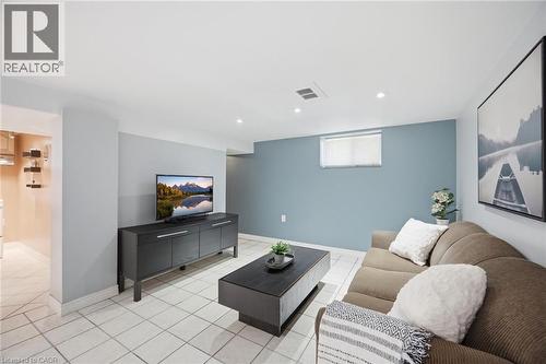 Finished lower level featuring recessed lighting, a window with blinds, and light-toned tile flooring - 94 Clarendon Avenue, Hamilton, ON - Indoor