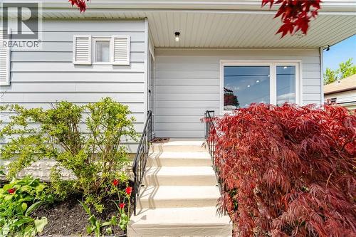 Front exterior featuring light gray horizontal siding, white trim, and white window shutters - 94 Clarendon Avenue, Hamilton, ON - Outdoor With Exterior