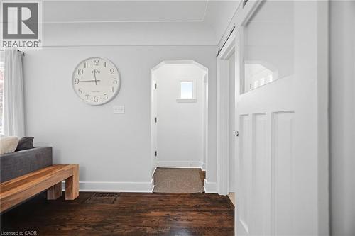 Rich wood-finish flooring complements a light gray wall color - 94 Clarendon Avenue, Hamilton, ON - Indoor Photo Showing Other Room