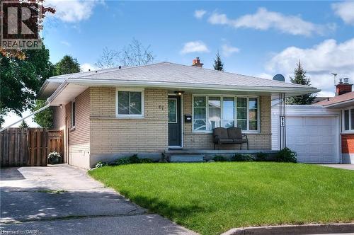 Bungalow residence featuring light-colored brick siding, a gray shingle roof, and a prominent front lawn - 61 Bosworth Crescent Unit# Upper, Kitchener, ON - Outdoor