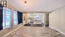 Open-concept living area featuring light wood-finish flooring, a modern chandelier, and a wide entryway to the kitchen - 61 Bosworth Crescent Unit# Upper, Kitchener, ON  - Indoor Photo Showing Other Room 