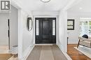 Grand entryway featuring a dark wood-finish door with sidelights, complemented by light-toned tile flooring and crown molding - 3500 Regal Road, Burlington, ON  - Indoor Photo Showing Other Room 