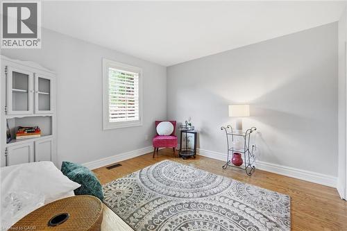 Hardwood flooring complements light gray walls in this room with a built-in display cabinet - 3500 Regal Road, Burlington, ON - Indoor