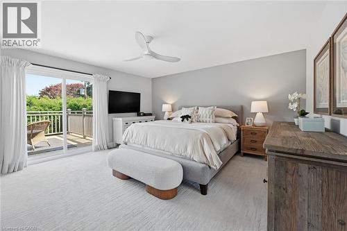 Room featuring light gray walls, plush patterned carpeting, and a contemporary ceiling fan - 3500 Regal Road, Burlington, ON - Indoor Photo Showing Bedroom