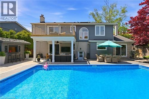 In-ground swimming pool featuring a surrounding concrete patio - 3500 Regal Road, Burlington, ON - Outdoor With In Ground Pool With Backyard