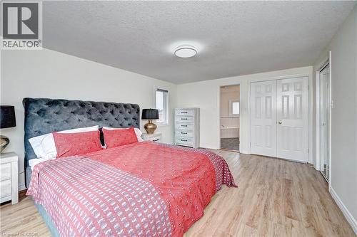 Spacious room featuring wood-finish flooring, white walls, and a recessed window - 519 Yorkshire Drive, Waterloo, ON - Indoor Photo Showing Bedroom